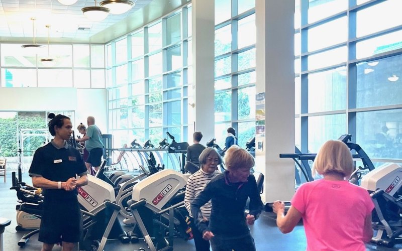 Faculty and staff participate in a group workout facilitated by a kinesiology graduate student.