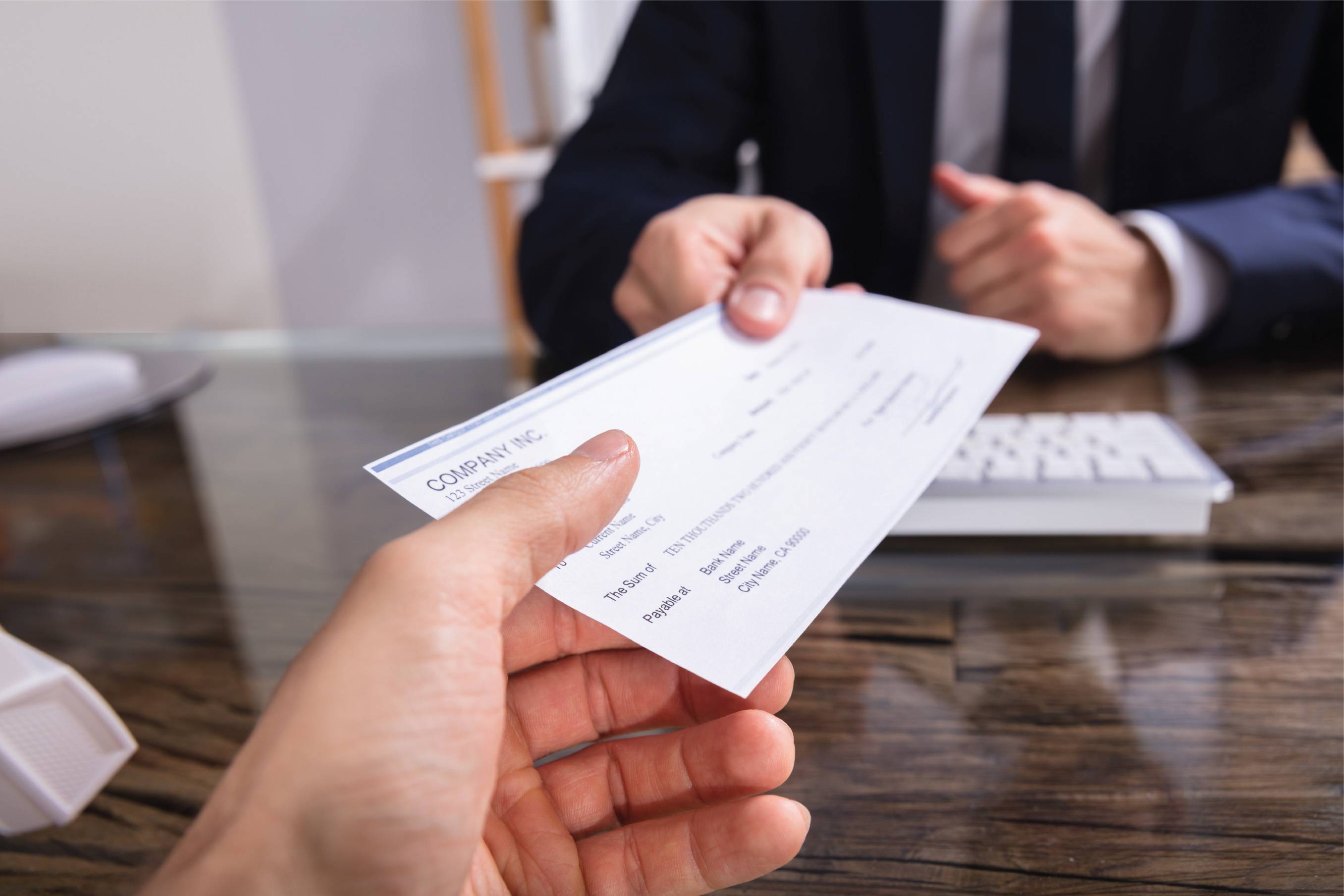 a check being handed off