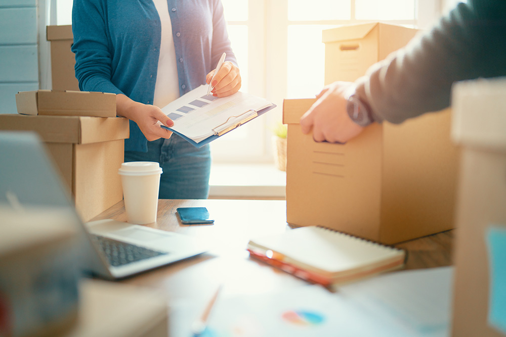 People packing boxes in an office